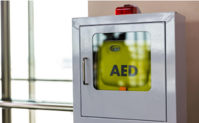 A ZOLL AED3 stored inside a wall cabinet, inside a public building.